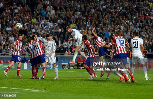 Sergio Ramos of Real Madrid heads in their first goal during the UEFA Champions League Final between Real Madrid and Atletico de Madrid at Estadio da...