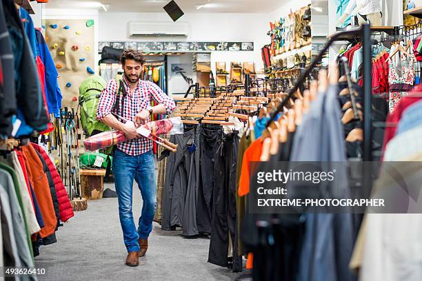 male customer in outdoor equipment store - sports equipment stock pictures, royalty-free photos & images