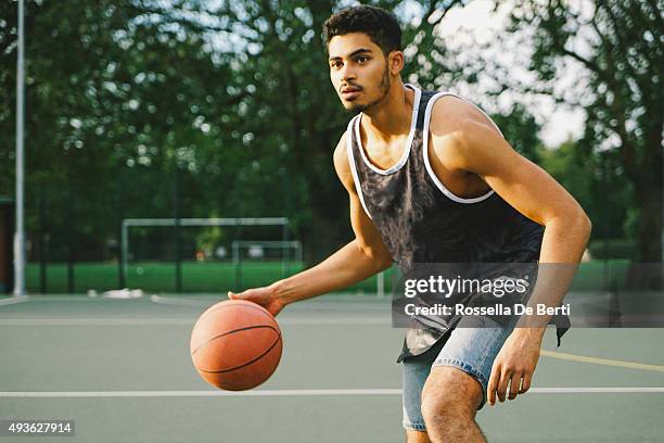 basketball player on the court facing opponents - dribbling basketball stock pictures, royalty-free photos & images