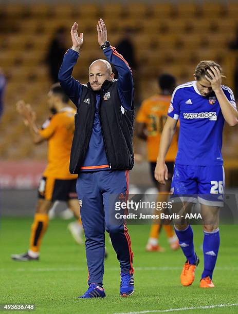 Lee Carsley the head coach / manager of Brentford applauds the travelling fans at the end of the Sky Bet Championship match between Wolverhampton...