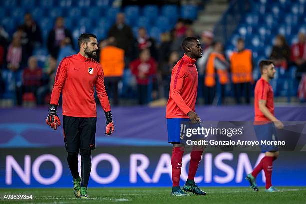 Atletico de Madrid palyers goalkeeper Miguel Angel Moya and his teammates Jackson Arley Martinez and Guilherme Madalena Siqueira warm up ahead the...