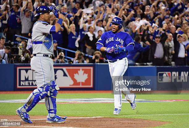 Edwin Encarnacion of the Toronto Blue Jays reacts as he scores a run in the sixth inning against the Kansas City Royals during game five of the...