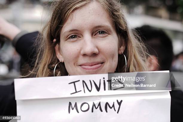 Film fans wait outside the Palais des Festivals holding signs in the hope of getting a ticket to one of the many films showing during the 67th Annual...