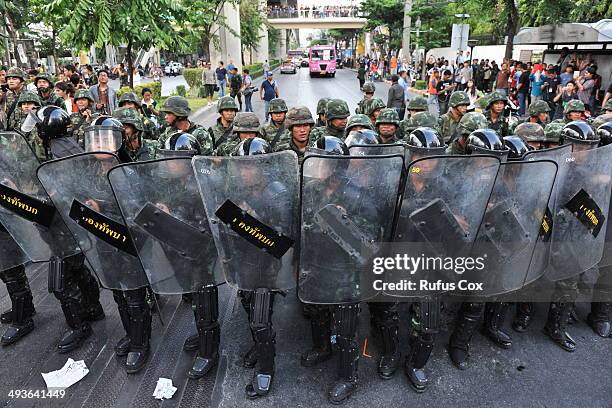 Thai army soldiers stand guard as anti-coup protesters rally nearby on May 24, 2014 in Bangkok, Thailand. The Thai capital has seen several anti-coup...