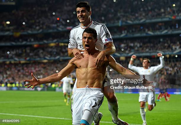 Cristiano Ronaldo of Real Madrid celebrates with r21 after scoring their fourth goal from the penalty spot during the UEFA Champions League Final...