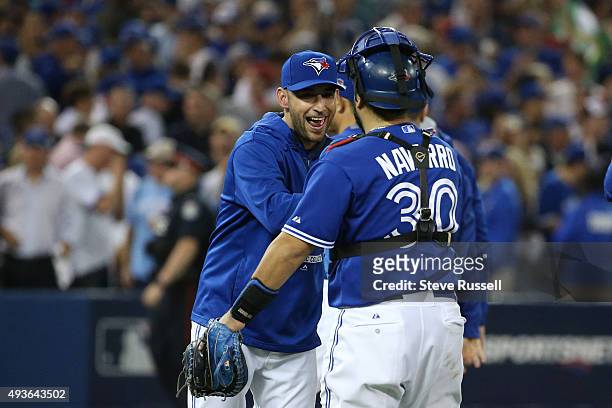 Marco Estrada hugs his catcher Dioner Navarro after the game. Estrada went 7.2 innings surrendering one run. The Toronto Blue Jays and the Kansas...