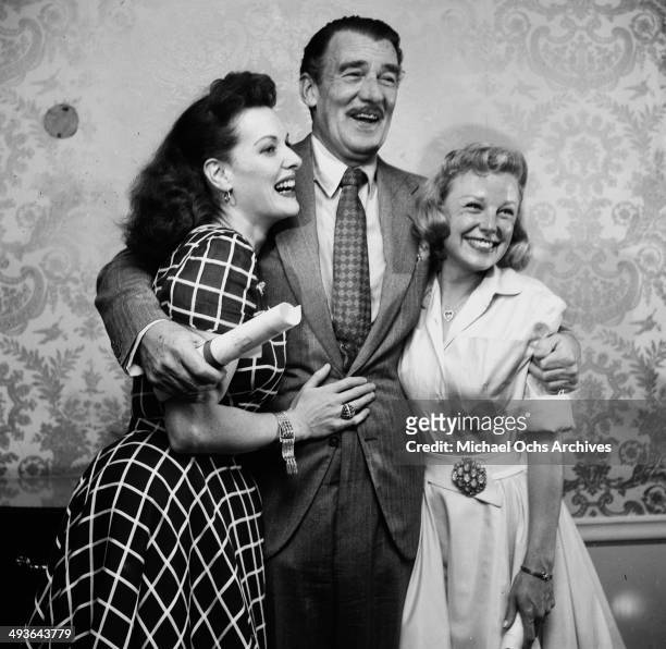 Actress Maureen O'Hara, actor Walter Pidgeon and actress June Allyson pose at a party in Los Angeles, California.