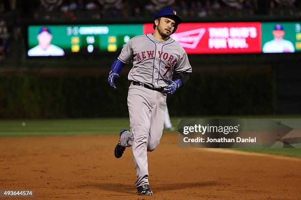 Travis d'Arnaud of the New York Mets rounds the bases after hitting a solo home run in the first inning against Jason Hammel of the Chicago Cubs...