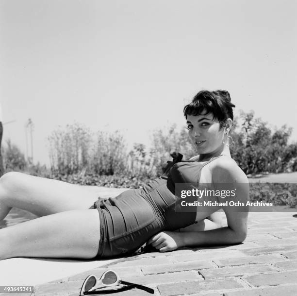 Jackie Collins poses at home by the pool in Los Angeles, California.