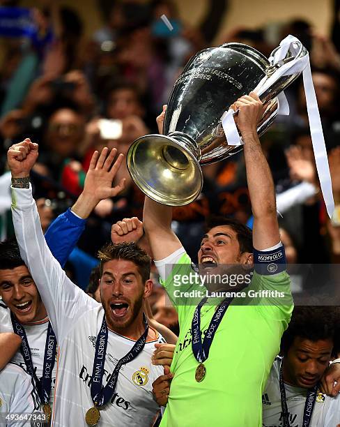 Iker Casillas of Real Madrid lifts the Champions League trophy as Sergio Ramos of Real Madrid celebrates during the UEFA Champions League Final...