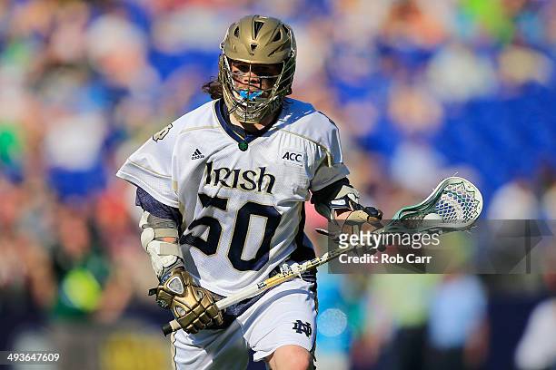 Matt Kavanagh of the Notre Dame Fighting Irish cradles the ball while looking to pass against the Maryland Terrapins in the second half during the...