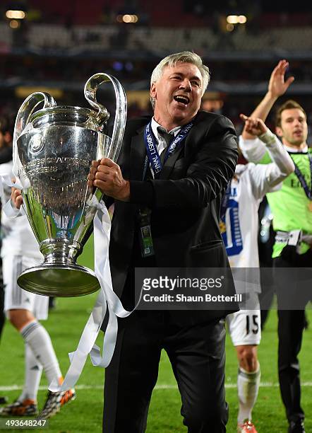 Head Coach, Carlo Ancelotti of Real Madrid celebrates with the Champions League trophy during the UEFA Champions League Final between Real Madrid and...