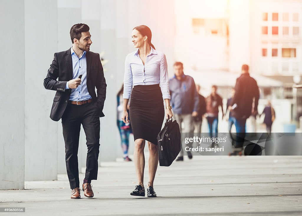 Business couple outdoors meeting