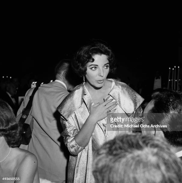 Joan Collins attends a Stanley Kramer party in Los Angeles, California.