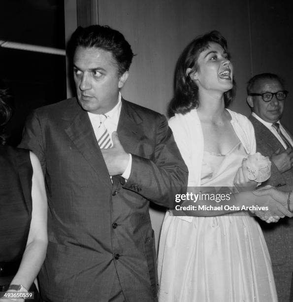 Director Federico Fellini and Gia Scala at his cocktail party in Los Angeles, California.