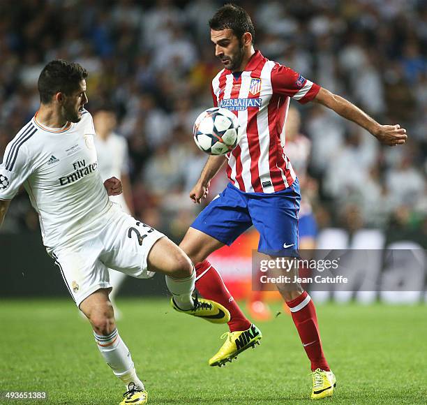 Isco of Real Madrid and Adrian Lopez Alvarez of Atletico Madrid in action during the UEFA Champions League final between Real Madrid and Atletico de...