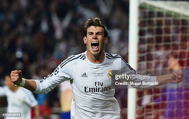 Gareth Bale of Real Madrid celebrates scoring their second goal in extra time during the UEFA Champions League Final between Real Madrid and Atletico...