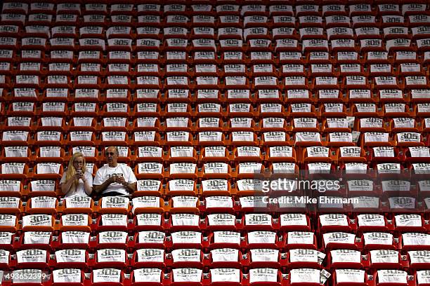Two fans sit in the arena surrounded by seats covered with game T-shirts prior to during Game Three of the Eastern Conference Finals between the...