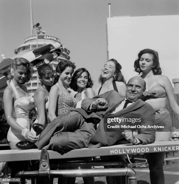 Actor Jackie Coogan poses with Patricia Deane, Patricia Craig, Jacqueline Sarrall, Kathi Thornton, Gloria Holliday, Joyce Andre in Los...