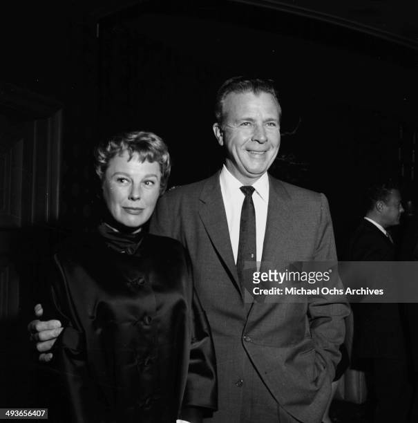 Director Dick Powell and actress June Allyson attend a party in Los Angeles, California.