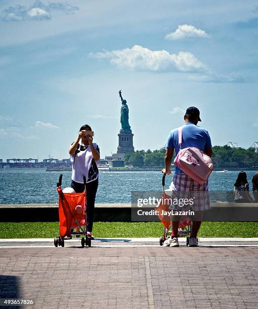 woman taking selfie, statue of liberty, lower manhattan, nyc - statue of liberty people stock pictures, royalty-free photos & images