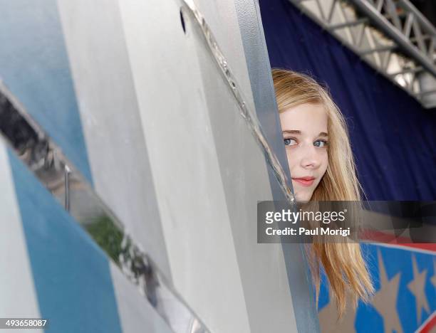 Jackie Evancho peeks around the corner to see what's happening onstage at the 25th National Memorial Day Concert rehearsals at U.S. Capitol West Lawn...