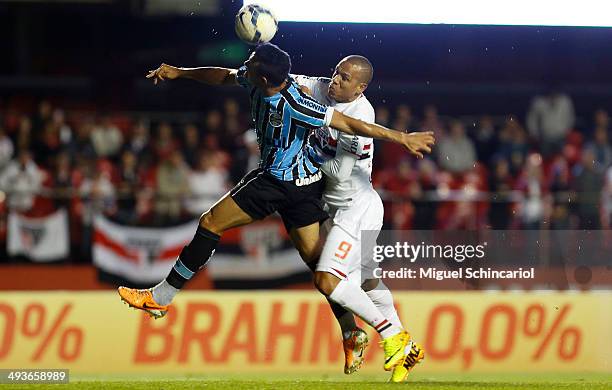 Luis Fabiano of Sao Paulo fights for the ball with Werley of Gremio, during a match between Sao Paulo and Gremio of Brasileirao Series A 2014 at...