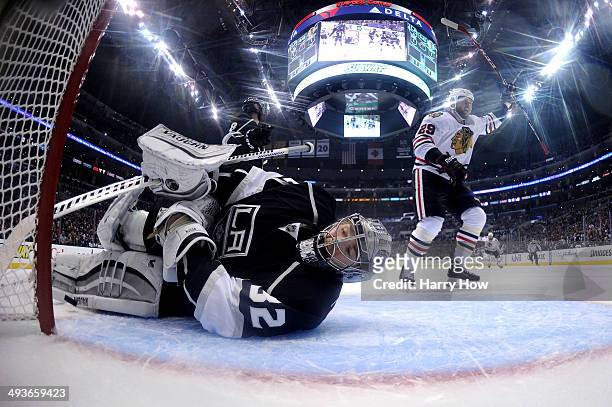 Goaltender Jonathan Quick of the Los Angeles Kings reacts after allowing the first goal of the game to Jonathan Toews as teammate Bryan Bickell of...