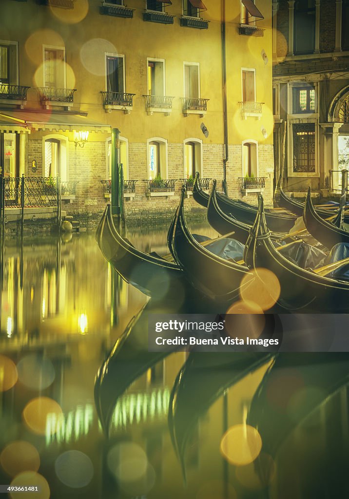 Gondolas in a channel of Venice at night