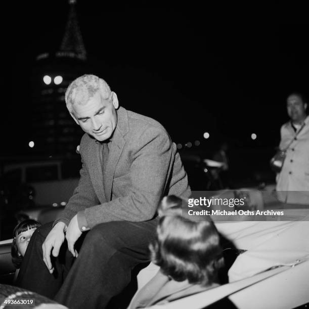 Actor Jeff Chandler rides in the car during the Hollywood Christmas Parade in Los Angeles, California.