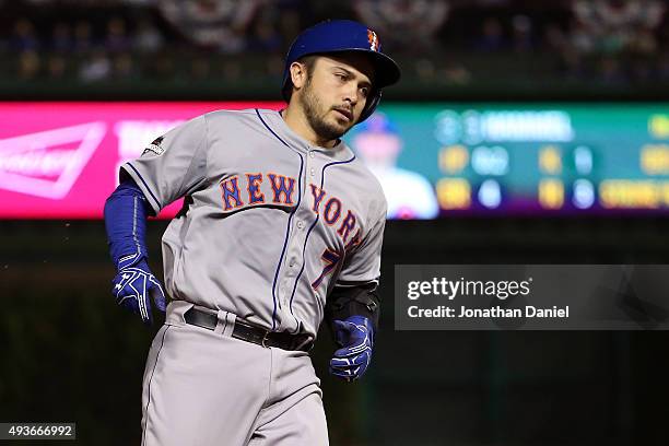 Travis d'Arnaud of the New York Mets rounds the bases after hitting a solo home run in the first inning against Jason Hammel of the Chicago Cubs...