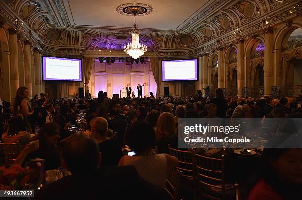 Auctioneer David Smith and Dr. Ben Neel speak on stage at NYU Langone Medical Center's Perlmutter Cancer Center Gala at The Plaza Hotel on October...