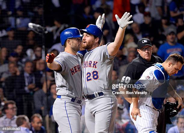 Daniel Murphy of the New York Mets celebrates with teammate David Wright after hitting a two-run home run in the top of the eighth inning of Game 4...