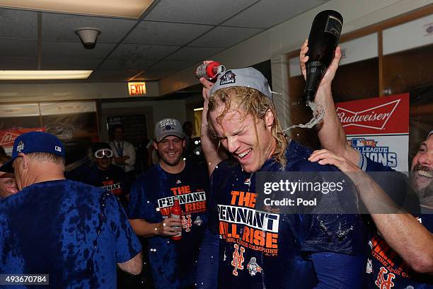 Noah Syndergaard of the New York Mets celebrates in the locker room with his teammates after defeating the Chicago Cubs in game four of the 2015 MLB...