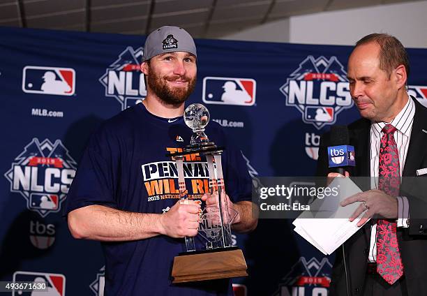 Daniel Murphy of the New York Mets poses with the NLCS MVP trophy after defeating the Chicago Cubs in game four of the 2015 MLB National League...