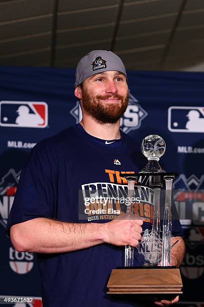 Daniel Murphy of the New York Mets poses with the NLCS MVP trophy after defeating the Chicago Cubs in game four of the 2015 MLB National League...