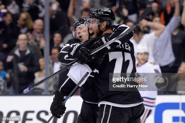 Jeff Carter and Tyler Toffoli of the Los Angeles Kings celebrate after Carter scores a second period goal against the Chicago Blackhawks in Game...