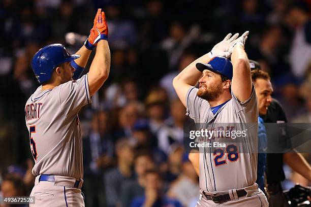 Daniel Murphy of the New York Mets celebrates with David Wright after hitting a two run home run in the eighth inning against Fernando Rodney of the...
