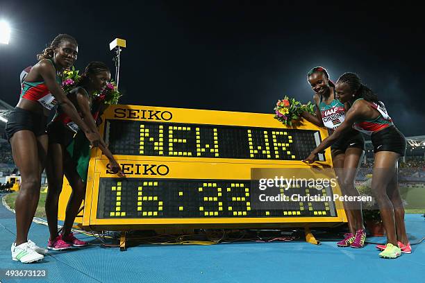 Irene Jelagat, Faith Chepngetich Kipyegon, Mercy Cherono and Hellen Onsando Obiri of Kenya pose together after setting a new world record of 16:33.58...