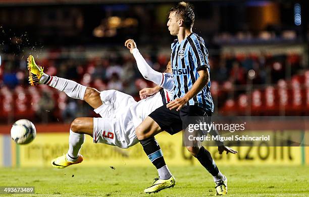 Luis Fabiano of Sao Paulo fights for the ball with Bressan of Gremio, during a match between Sao Paulo and Gremio of Brasileirao Series A 2014 at...