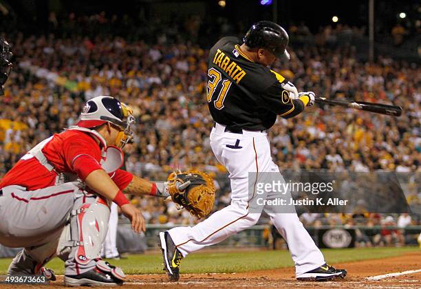 Jose Tabata of the Pittsburgh Pirates hits a sacrifice fly in the seventh inning against the Washington Nationals during the game at PNC Park May 24,...