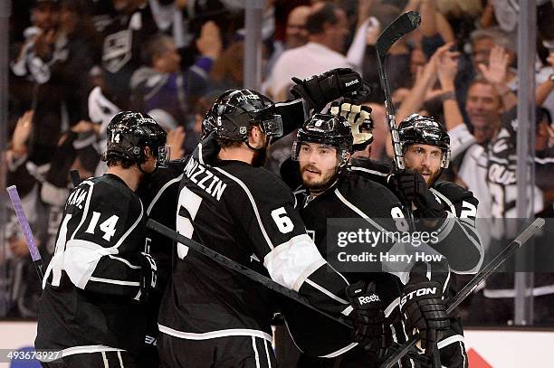 Drew Doughty of the Los Angeles Kings celebrates with teammates after he scores a third period goal against the Chicago Blackhawks in Game Three of...