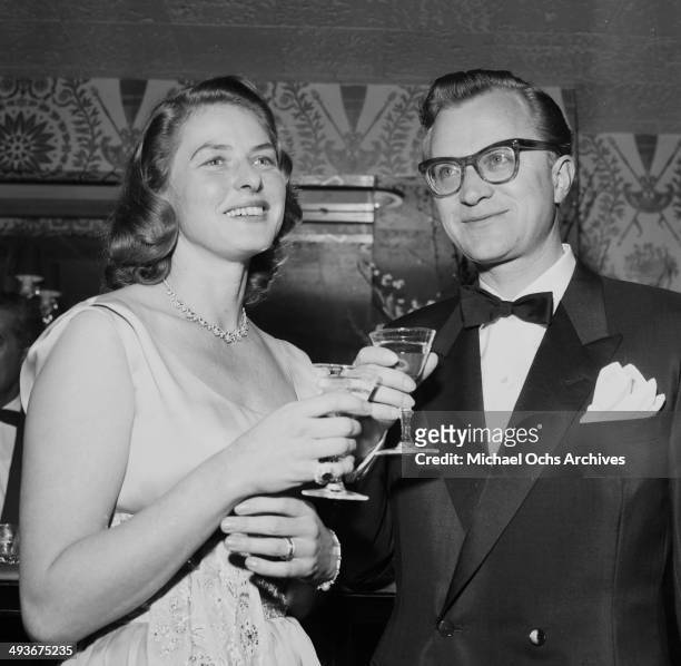Swedish actress Ingrid Bergman with husband Lars Schmidt attends a party in Los Angeles, California.