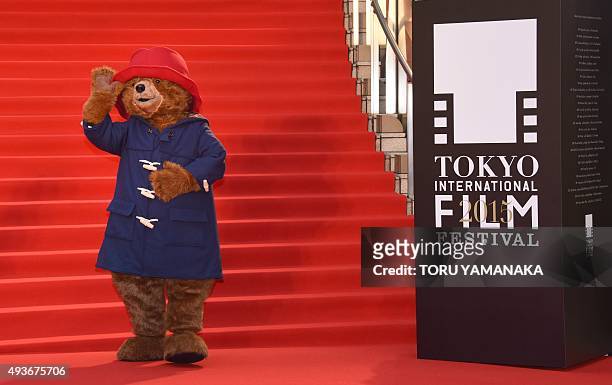 Paddington Bear waves to photographers on the red carpet upon its arrival for the opening ceremony of the 28th Tokyo International Film Festival in...