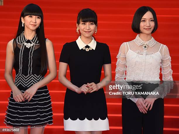 Members of Japanese pop group Perfume Kashiyuka, A-chan, and Nocchi appear before photographers on the red carpet upon their arrival for the opening...