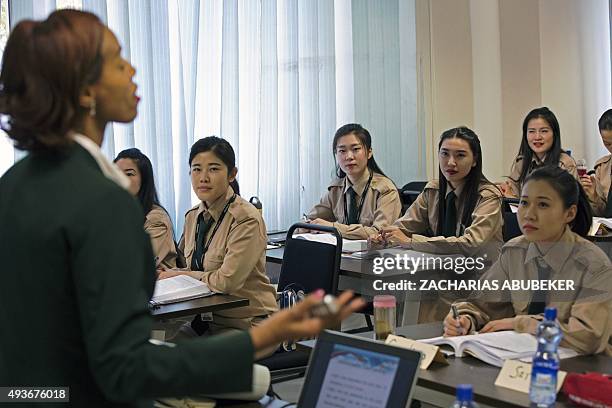 Chinese cabin crew listen to a lesson in a class room on the campus of the Ethiopian Airlines flight academy in Addis Ababa on October 13, 2015....