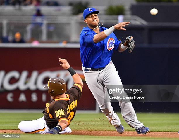 Shortstop Starlin Castro of the Chicago Cubs throws past Everth Cabrera of the San Diego Padres as he turns a double play during the first inning of...