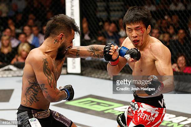 Francisco Rivera punches Takeya Mizugaki in their bantamweight bout during the UFC 173 event at the MGM Grand Garden Arena on May 24, 2014 in Las...