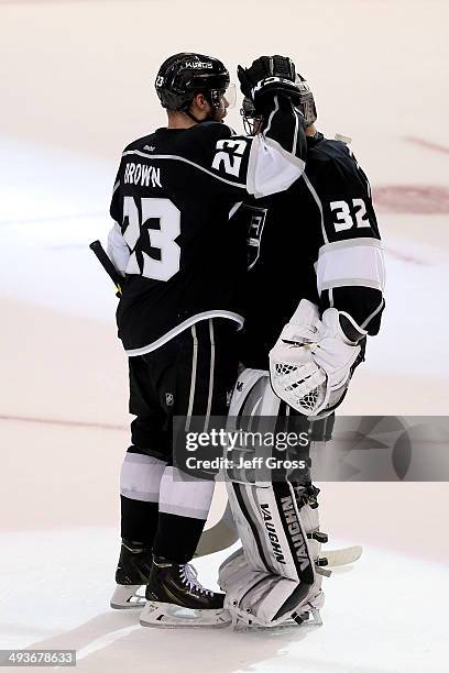 Dustin Brown celebrates with goaltender Jonathan Quick of the Los Angeles Kings after the Kings 4-3 victory against the Chicago Blackhawks in Game...