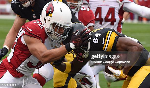 Safety Tyrann Mathieu of the Arizona Cardinals tackles wide receiver Antonio Brown of the Pittsburgh Steelers during a game at Heinz Field on October...